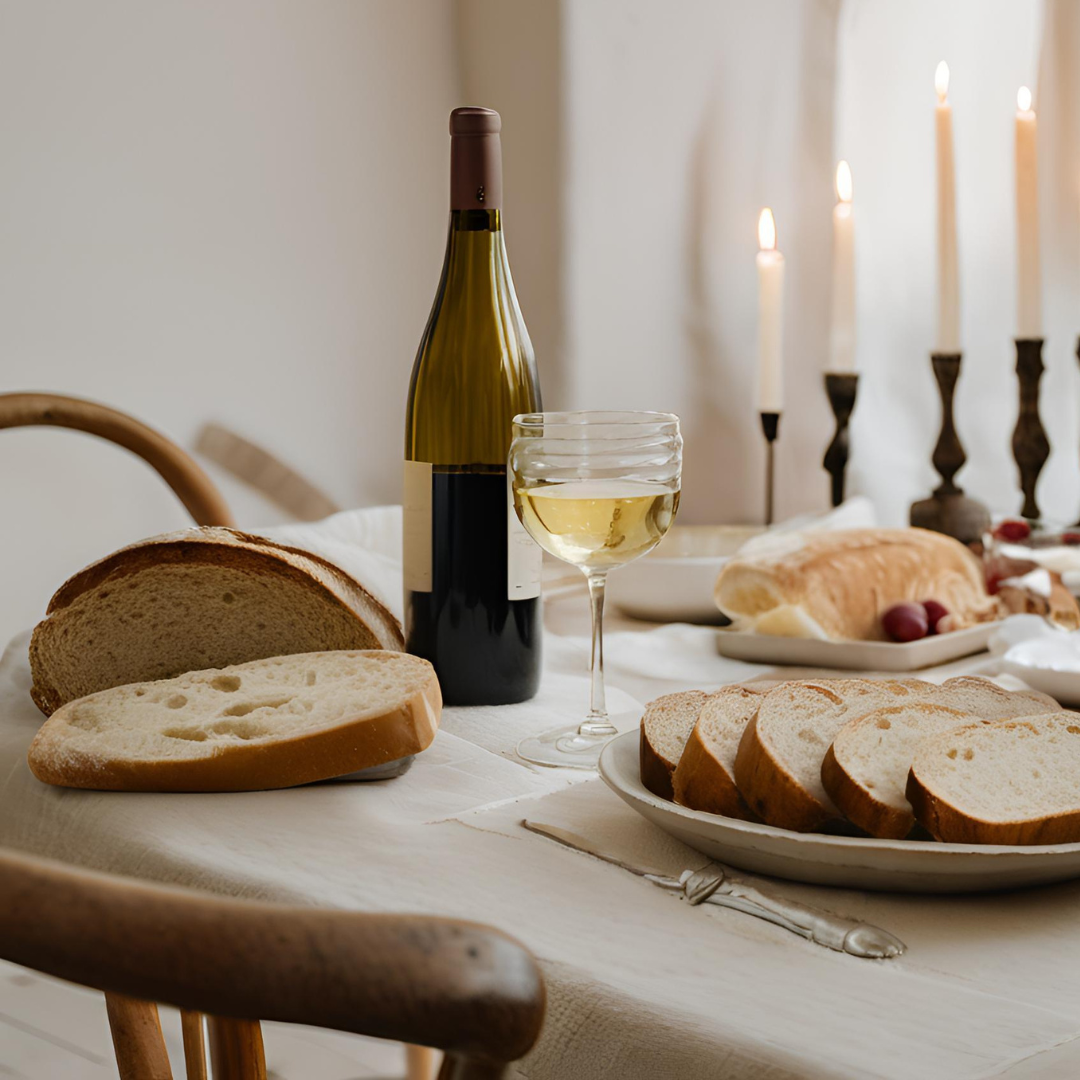 A rustic French table adorned with bread, wine, and candles, showcasing the art of enjoying meals in a mindful, relaxed manner.