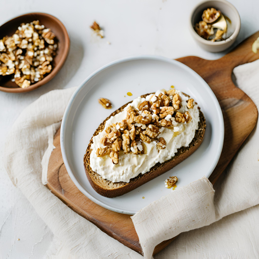 Whole-grain toast topped with creamy ricotta, crunchy walnuts, and a drizzle of honey—an elegant Mediterranean breakfast or snack.