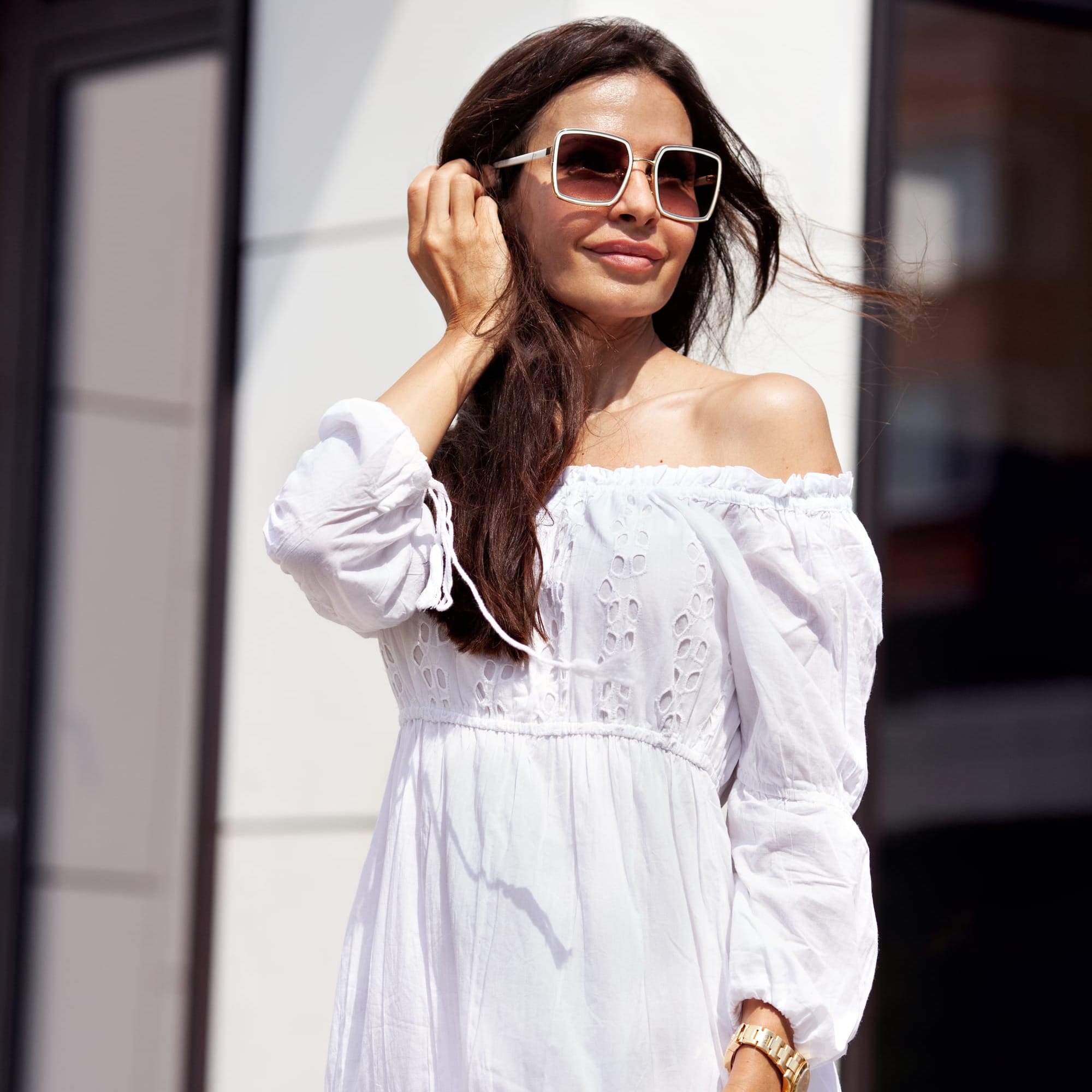 Woman in white summer dress with long hair and white retro square sunglasses